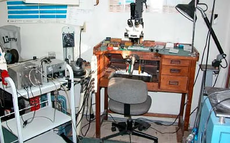 The workshop: a jeweller's bench with microscope, lamps and tools